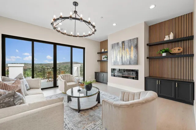a living room with furniture and a chandelier