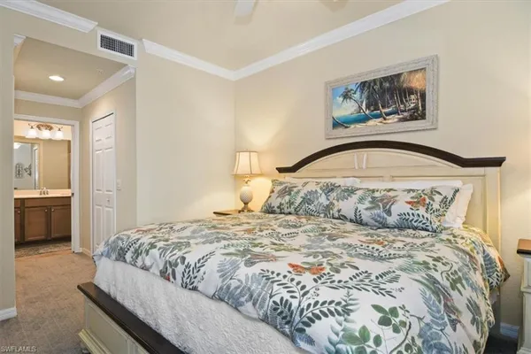 a bedroom with a large bed and a view of bathroom