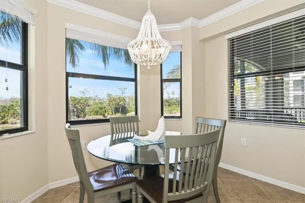 a view of a dining room with furniture a chandelier and wooden floor