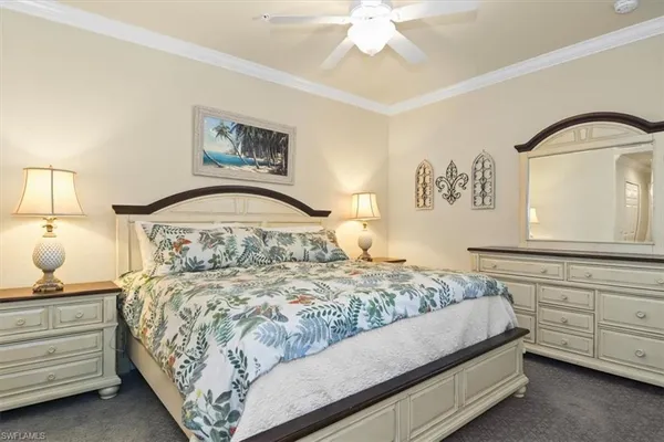 a bedroom with a bed and a mirror on dresser
