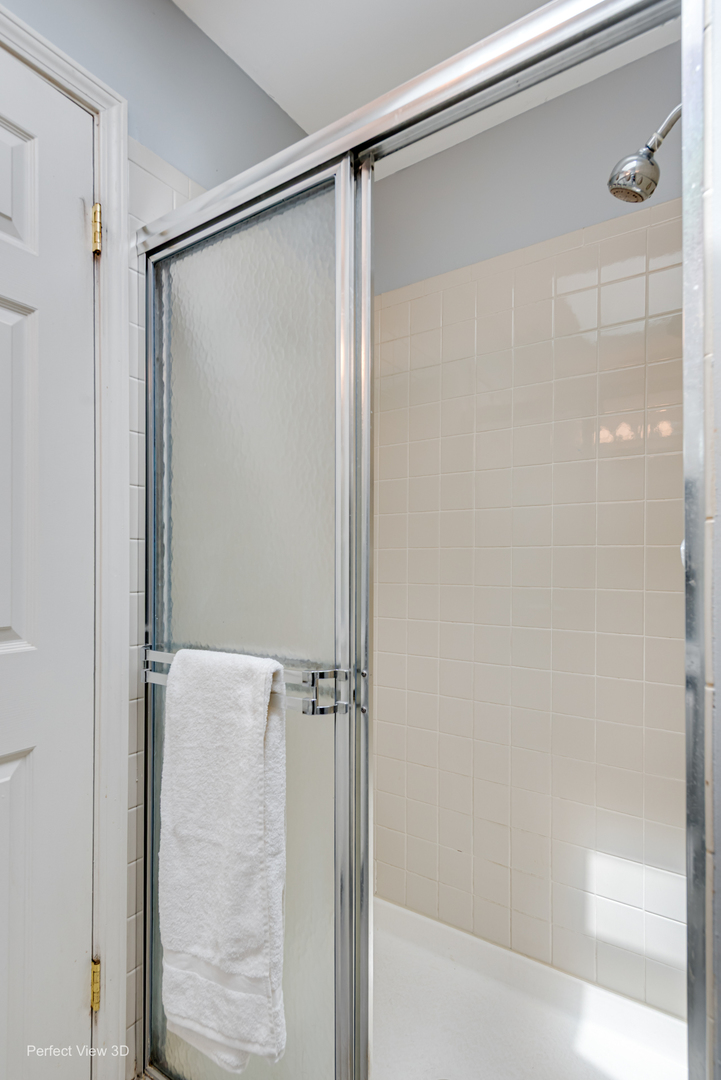 -n120 Windermere Road, Unit 2008 Winfield, IL 60190 - Photo 16 of 23 a bathroom with a glass shower door