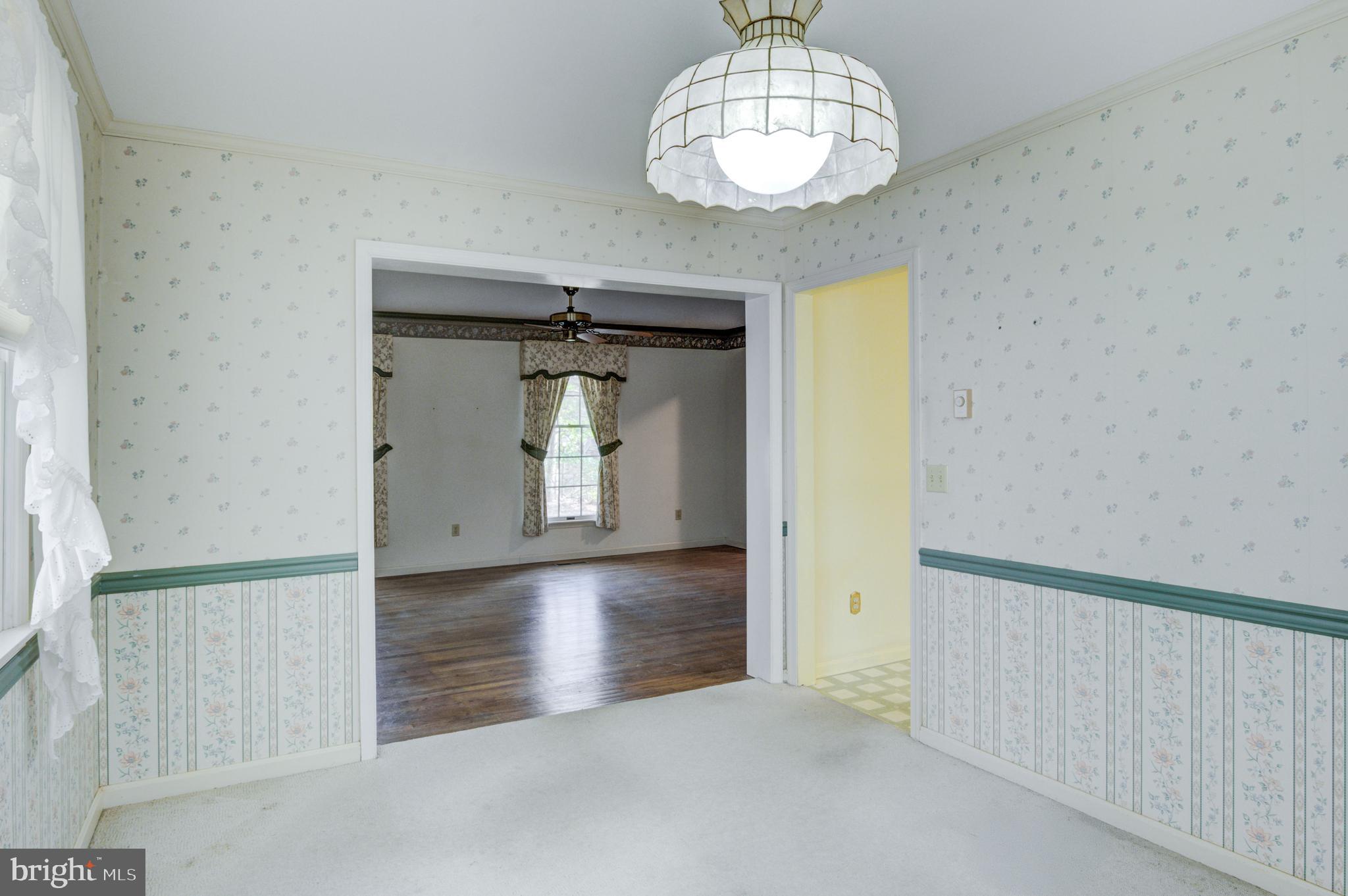 16 Canal Road Ocean Pines, MD 21811 - Photo 16 of 56 an empty room with wooden floor and chandelier