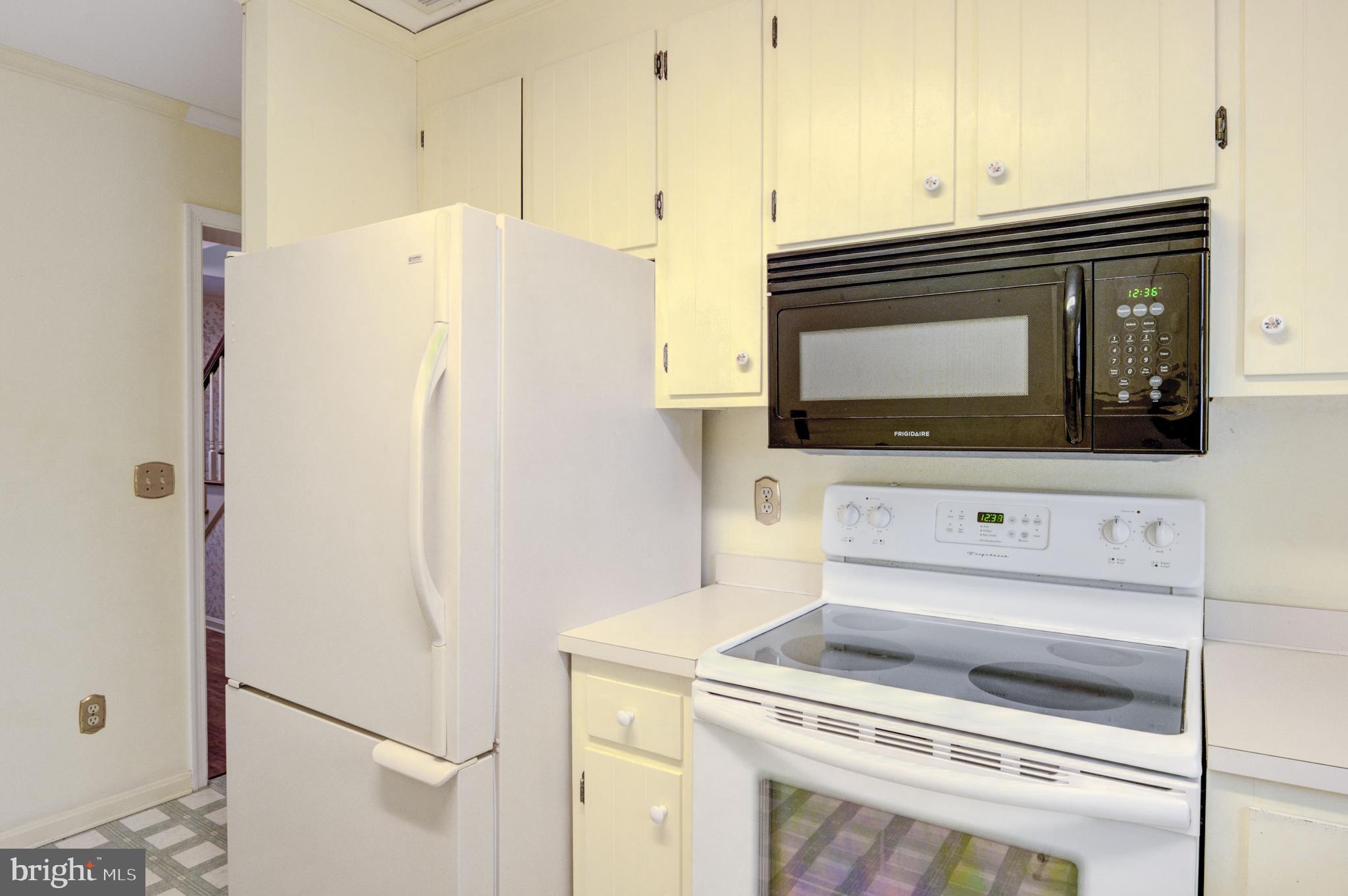 16 Canal Road Ocean Pines, MD 21811 - Photo 20 of 56 a kitchen with a refrigerator stove and microwave