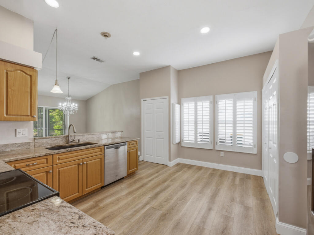 3650 Kent Drive Naples, FL 34112 - Photo 13 of 17 a large kitchen with a large counter top a sink stainless steel appliances and cabinets