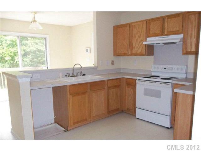10807 Azure Valley Place Charlotte, NC 28269 - Photo 2 of 13 a kitchen with cabinets appliances a sink and a window