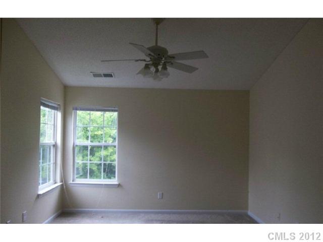 10807 Azure Valley Place Charlotte, NC 28269 - Photo 5 of 13 a view of a livingroom with a ceiling fan and window