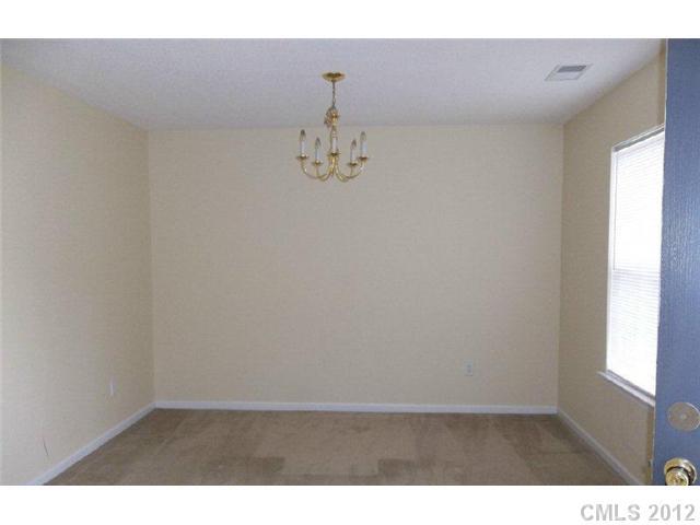 10807 Azure Valley Place Charlotte, NC 28269 - Photo 8 of 13 a view of wooden floor and chandelier in a room