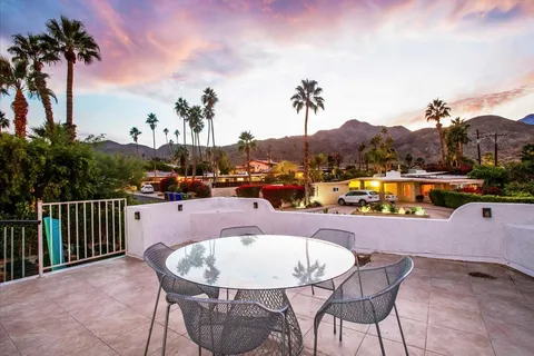 a kitchen with stainless steel appliances kitchen island granite countertop a sink and a refrigerator
