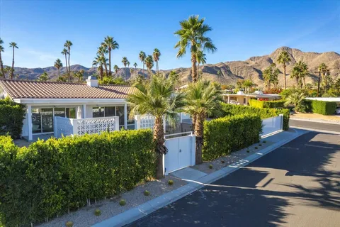 a view of a chairs and table in the patio with a couple of chairs