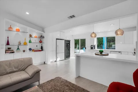 a view of a house with backyard sitting area and swimming pool