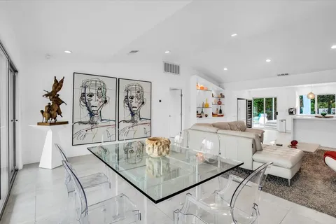 a view of patio with chairs and table under an umbrella