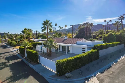 a view of a chairs and table in the back yard of the house