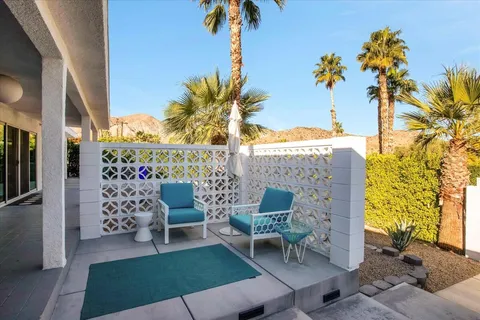 a living room with furniture and a floor to ceiling window