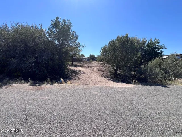 a view of snow on a road near a building