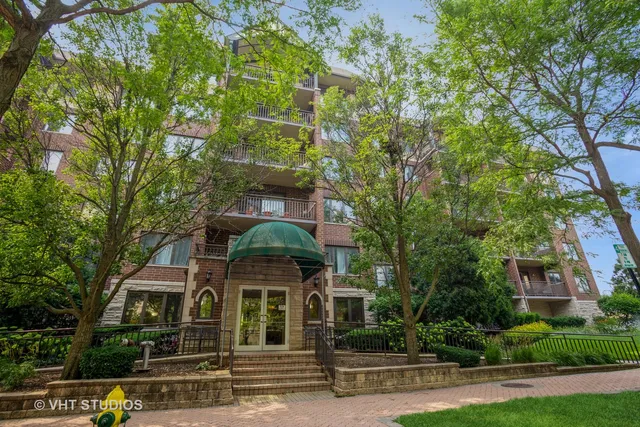 front view of a building with a tree