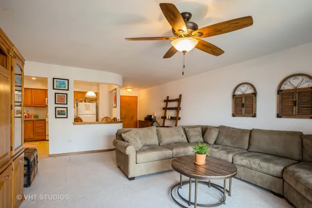 a living room with furniture and a ceiling fan