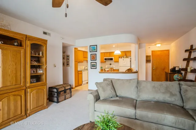 a living room with furniture and a view of kitchen