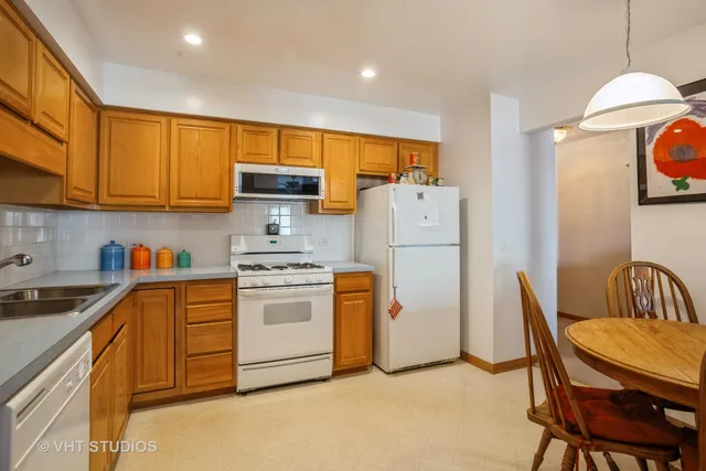 a kitchen with refrigerator a stove a sink and a refrigerator