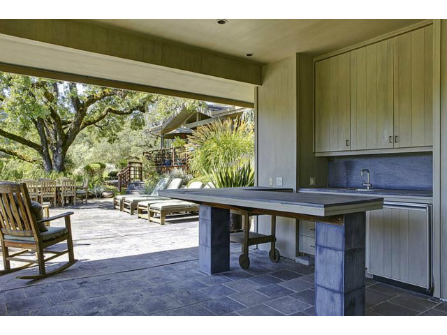 150 Farm Road Woodside, CA 94062 - Photo 5 of 19 a kitchen with a wooden table and chairs