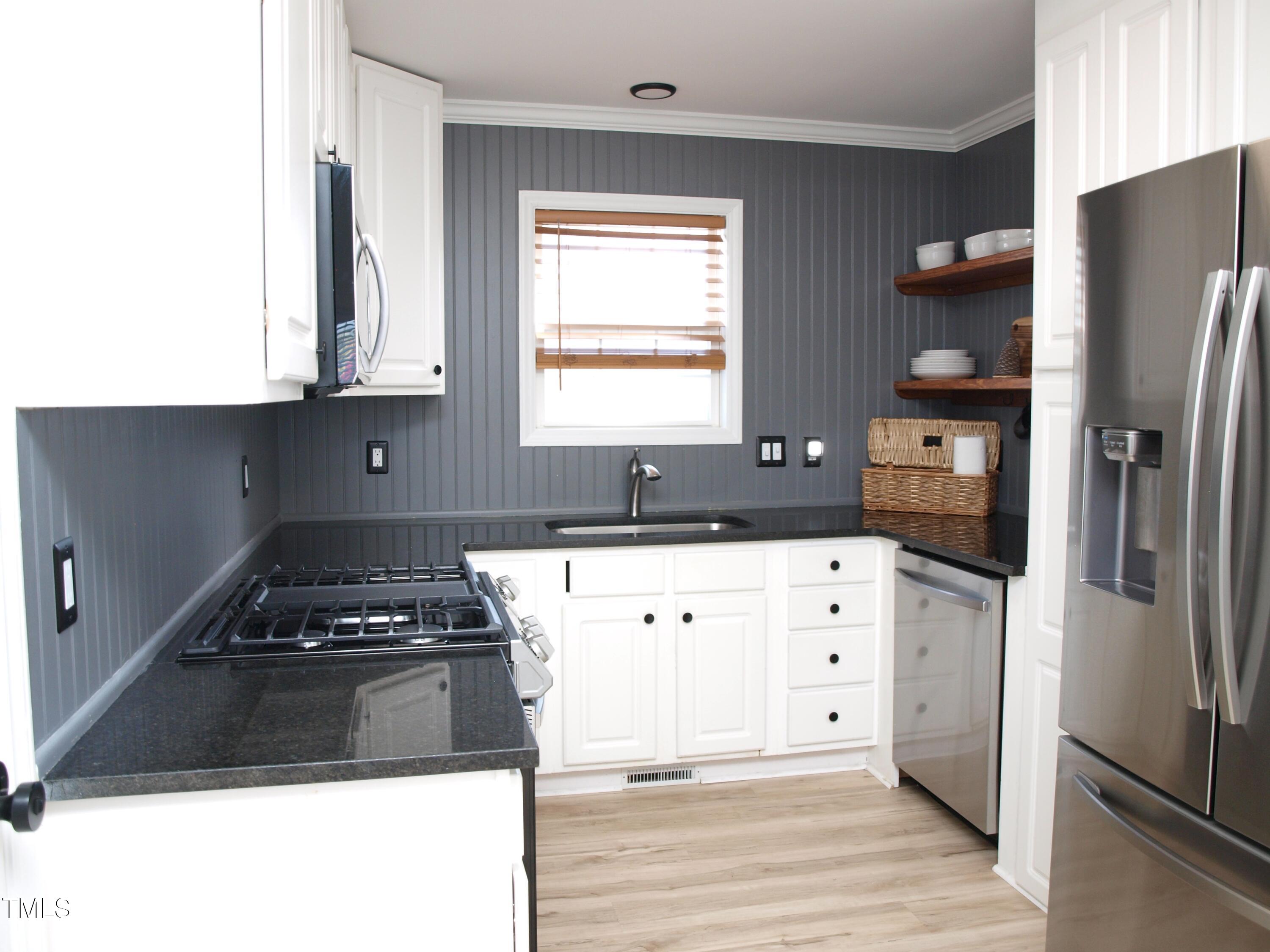 4500 Bartholomew Circle Raleigh, NC 27604 - Photo 4 of 22 a kitchen with a refrigerator and a stove