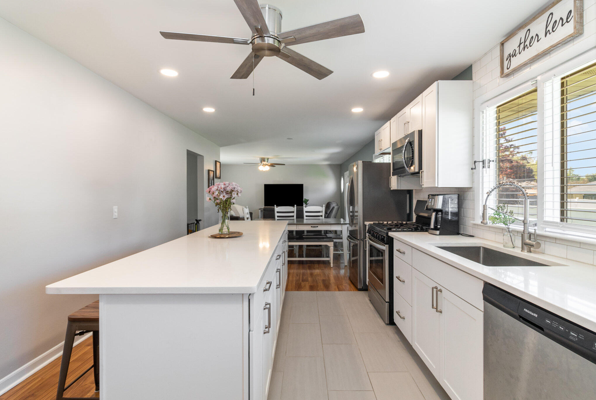 3131 Wirth Road Highland, IN 46322 - Photo 10 of 31 a kitchen with a sink a counter top space stainless steel appliances and a window