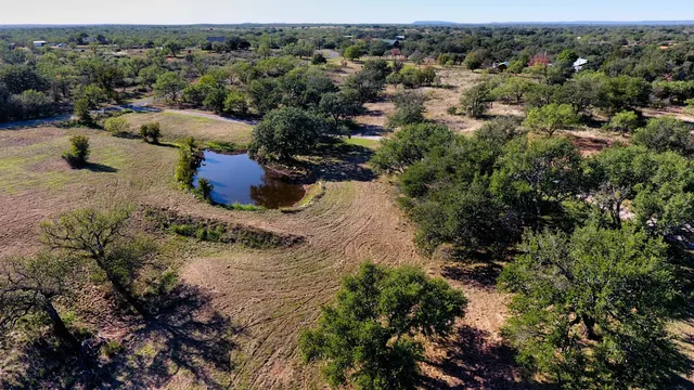 an aerial view of a houses with a yard