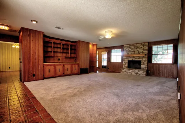 an empty room with windows and closet