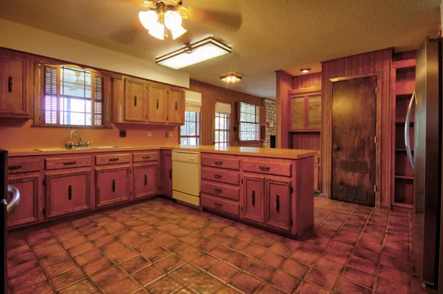 a kitchen with stainless steel appliances granite countertop a stove a sink dishwasher and a refrigerator