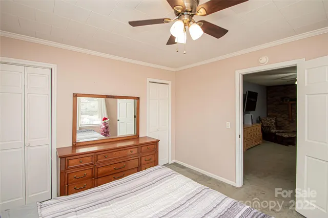 a room with wooden floor and ceiling fan