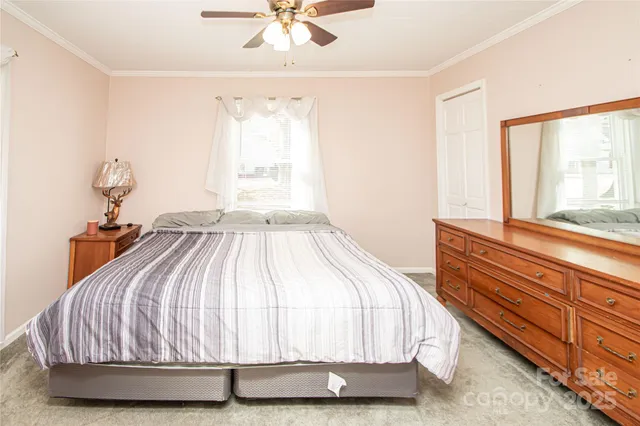 a bedroom with a bed and painting on the wall