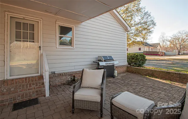 a view of a patio with a chairs and table in the patio