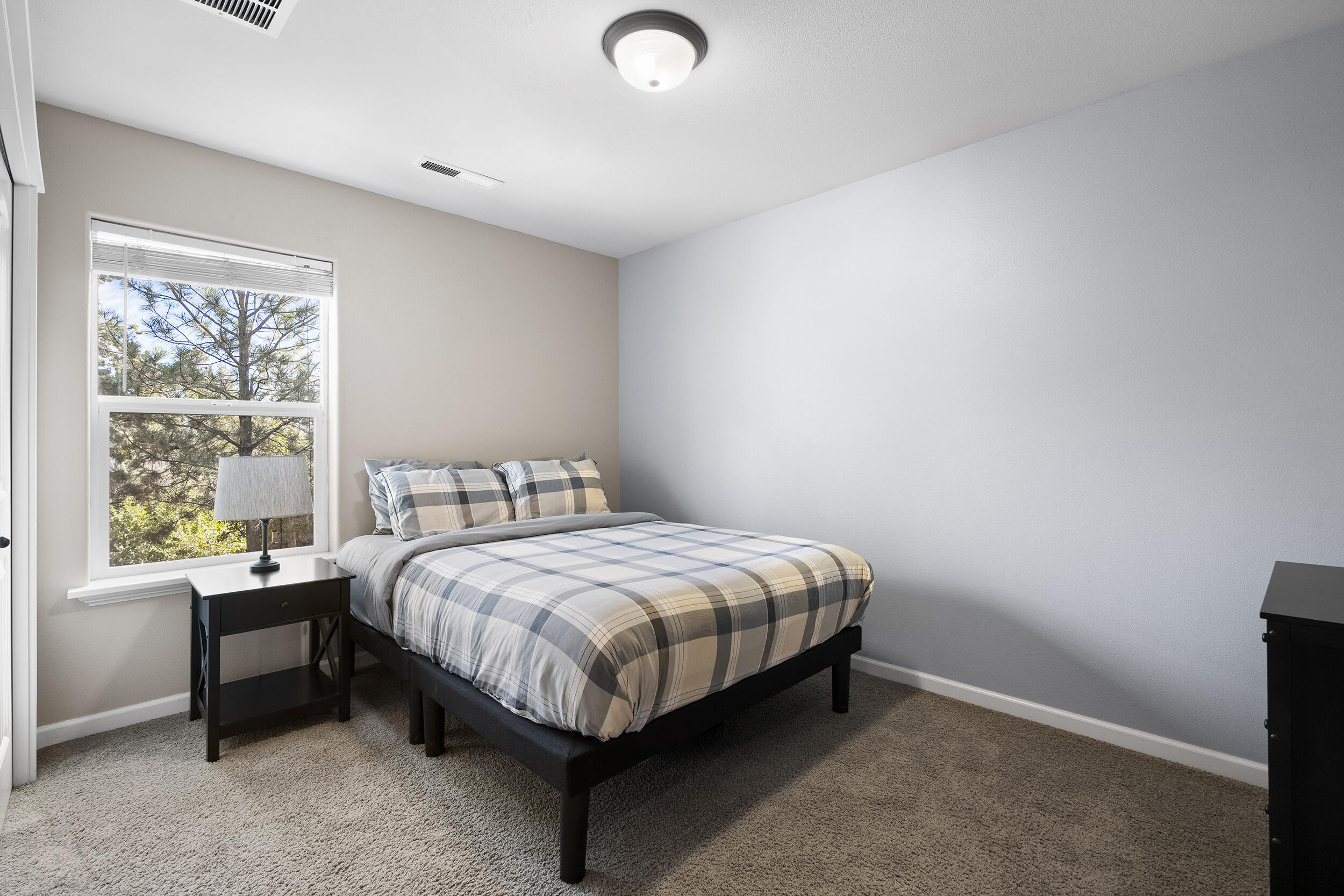 62906 Bilyeu Way Bend, OR 97701 - Photo 75 of 100 a bed sitting in a bedroom next to a window