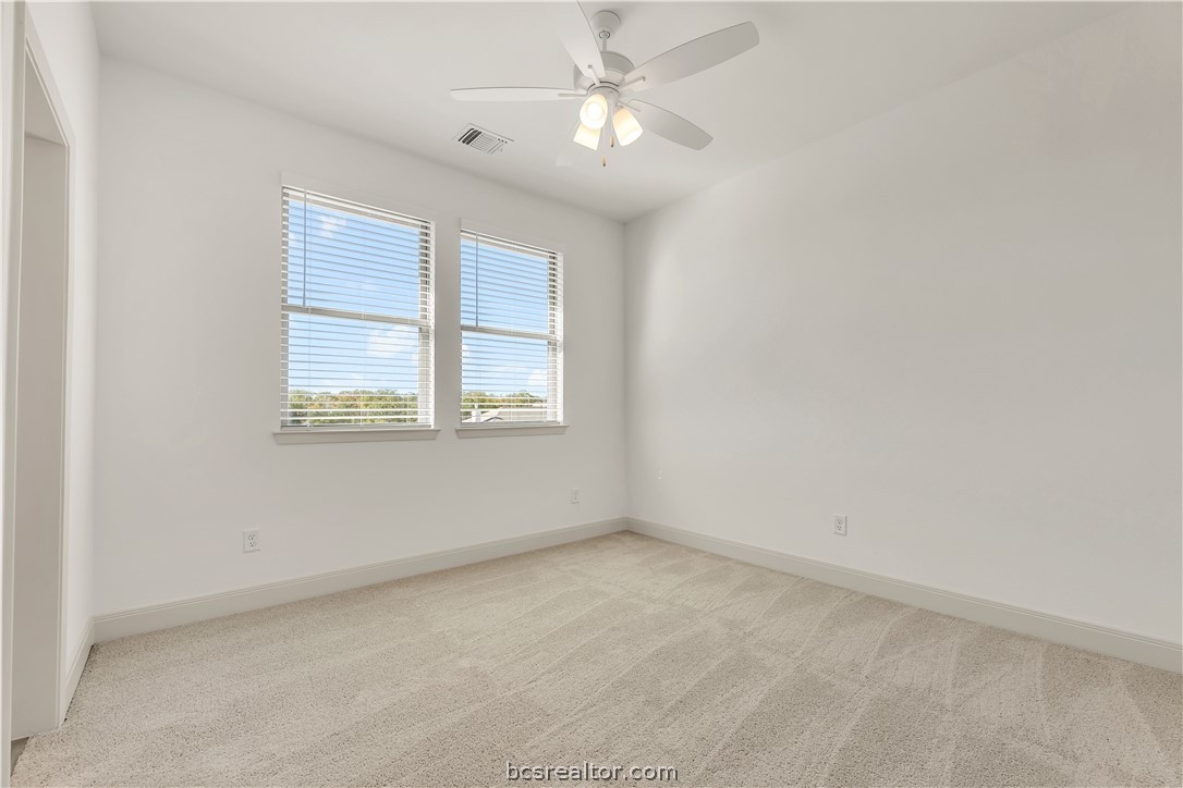 5084 Acadia Loop Bryan, TX 77802 - Photo 32 of 33 an empty room with a window and a fan