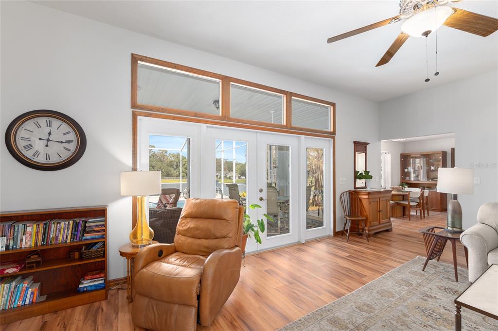 12094 Southeast 60th Avenue Road Belleview, FL 34420 - Photo 12 of 74 a living room with furniture a bookshelf and a large window