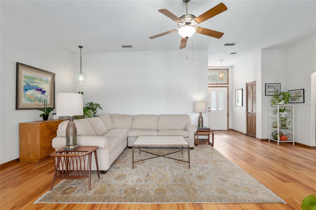 12094 Southeast 60th Avenue Road Belleview, FL 34420 - Photo 14 of 74 a living room with furniture and wooden floor