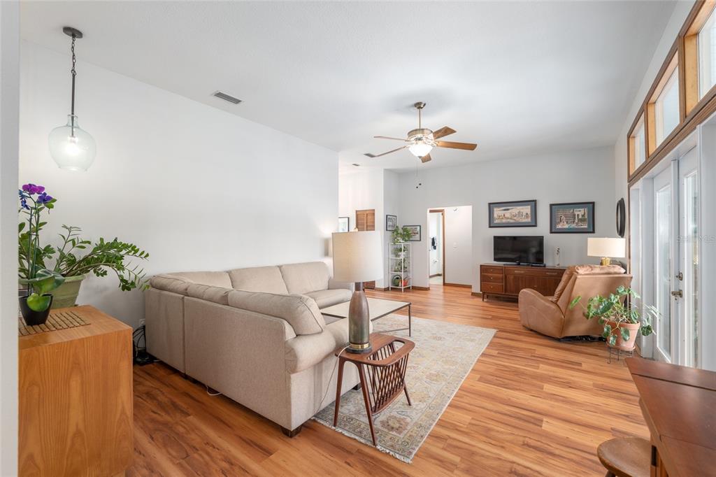 12094 Southeast 60th Avenue Road Belleview, FL 34420 - Photo 17 of 74 a living room with furniture and a chandelier