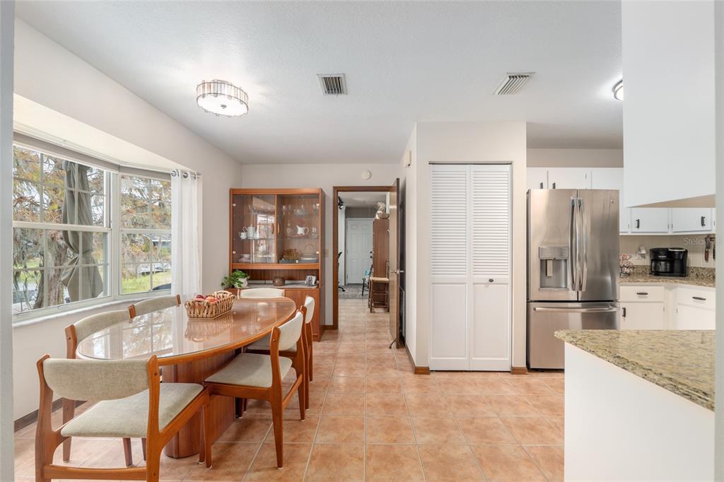 12094 Southeast 60th Avenue Road Belleview, FL 34420 - Photo 18 of 74 a kitchen with stainless steel appliances kitchen island granite countertop a refrigerator and a stove top oven