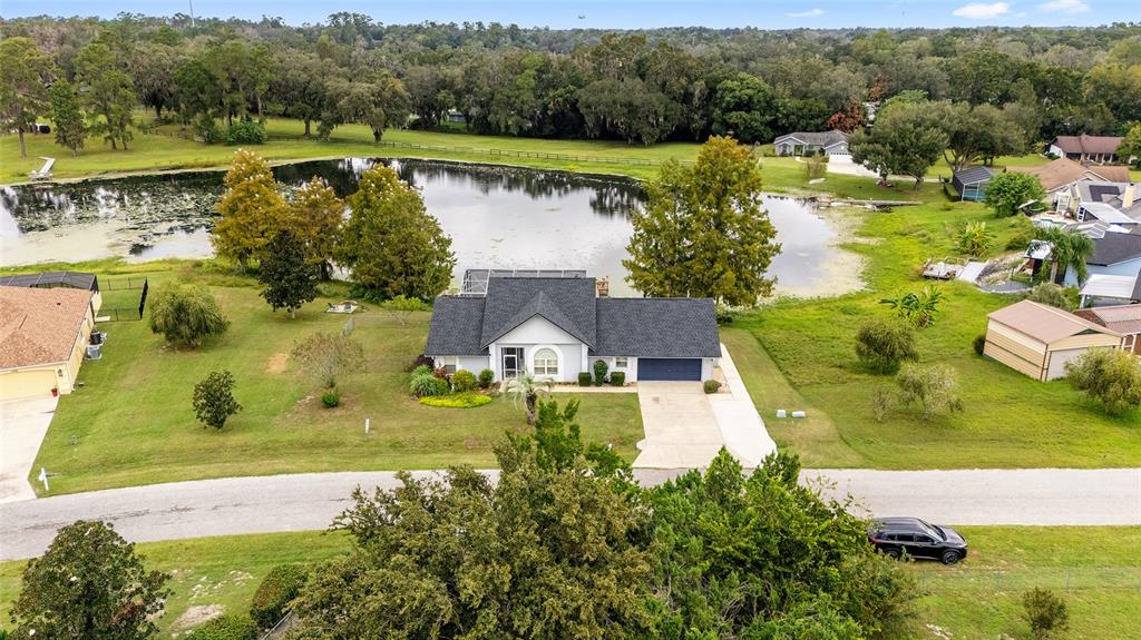 12094 Southeast 60th Avenue Road Belleview, FL 34420 - Photo 2 of 74 an aerial view of residential houses with outdoor space