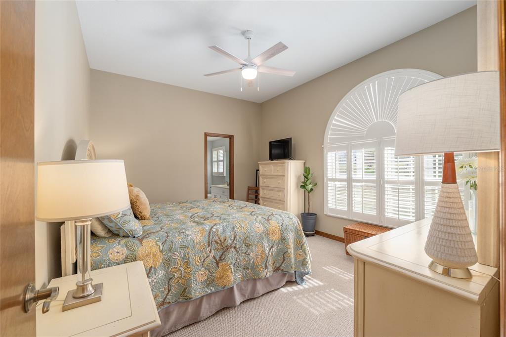 12094 Southeast 60th Avenue Road Belleview, FL 34420 - Photo 26 of 74 a bedroom with a bed and large windows