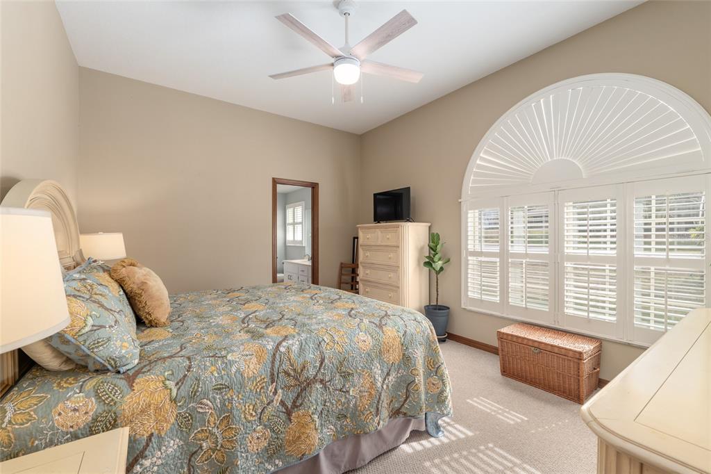 12094 Southeast 60th Avenue Road Belleview, FL 34420 - Photo 27 of 74 a bedroom with a bed and a large window