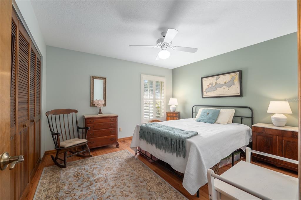 12094 Southeast 60th Avenue Road Belleview, FL 34420 - Photo 36 of 74 a bedroom with a bed and a chandelier