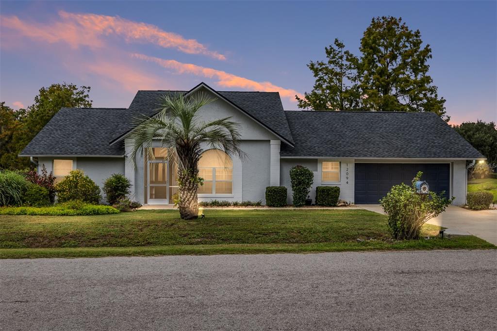 12094 Southeast 60th Avenue Road Belleview, FL 34420 - Photo 4 of 74 a front view of a house with a yard and garage