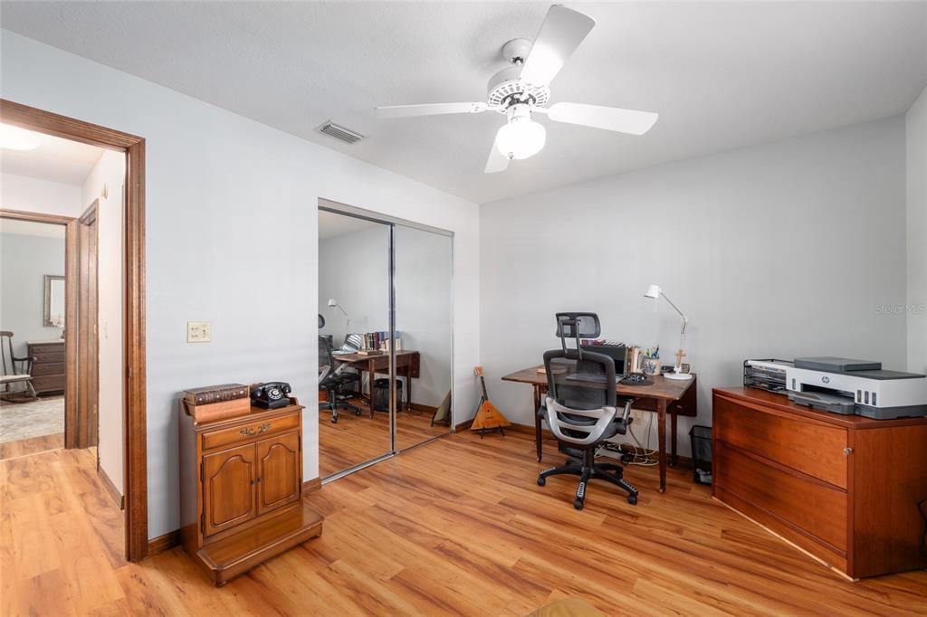 12094 Southeast 60th Avenue Road Belleview, FL 34420 - Photo 41 of 74 a workspace with furniture wooden floor and a chandelier