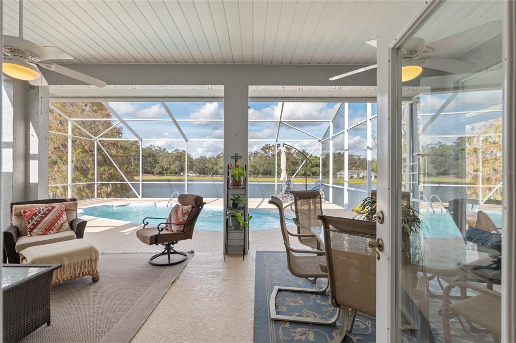 12094 Southeast 60th Avenue Road Belleview, FL 34420 - Photo 42 of 74 a living room with furniture and floor to ceiling windows