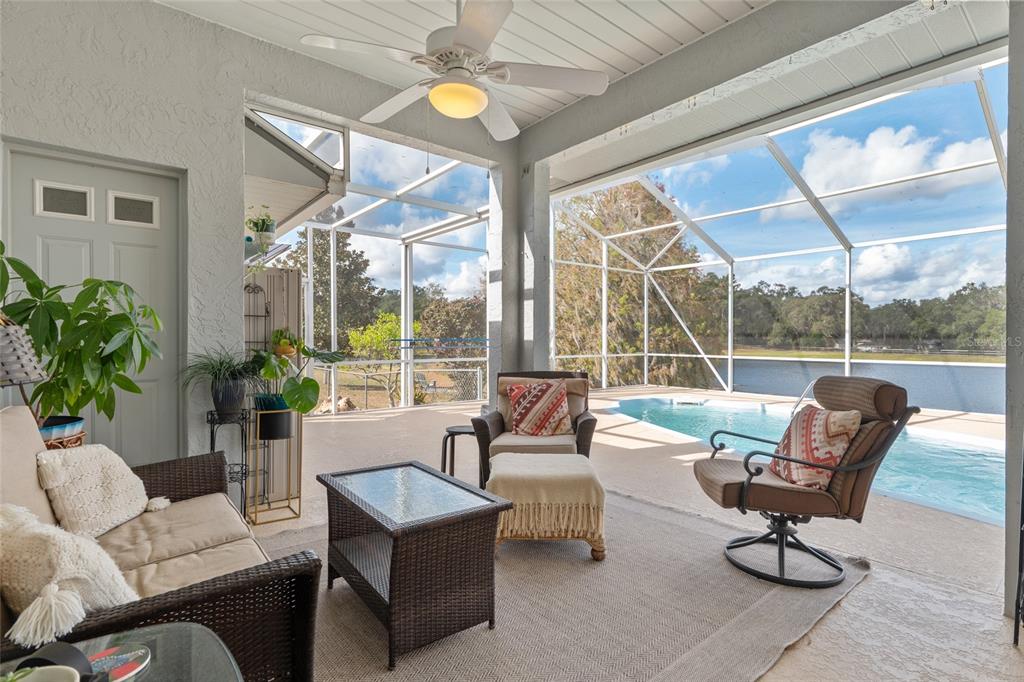 12094 Southeast 60th Avenue Road Belleview, FL 34420 - Photo 45 of 74 a living room with furniture and a large window with garden view