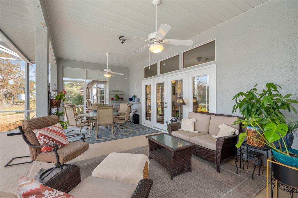 12094 Southeast 60th Avenue Road Belleview, FL 34420 - Photo 46 of 74 a living room with furniture a chandelier and a dining table