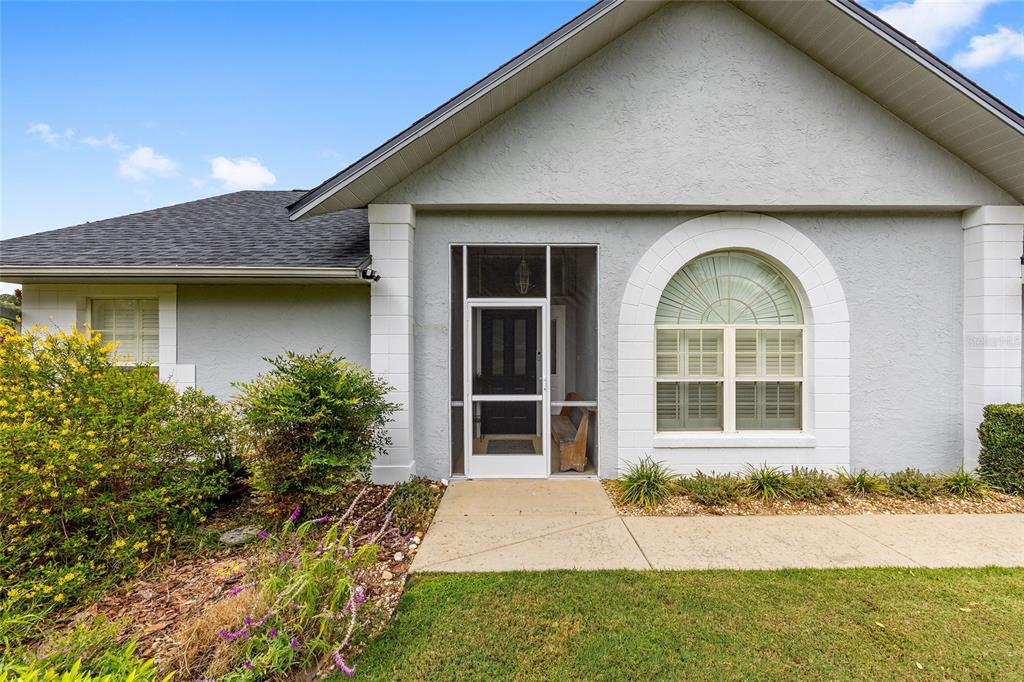 12094 Southeast 60th Avenue Road Belleview, FL 34420 - Photo 6 of 74 a house view with a garden space