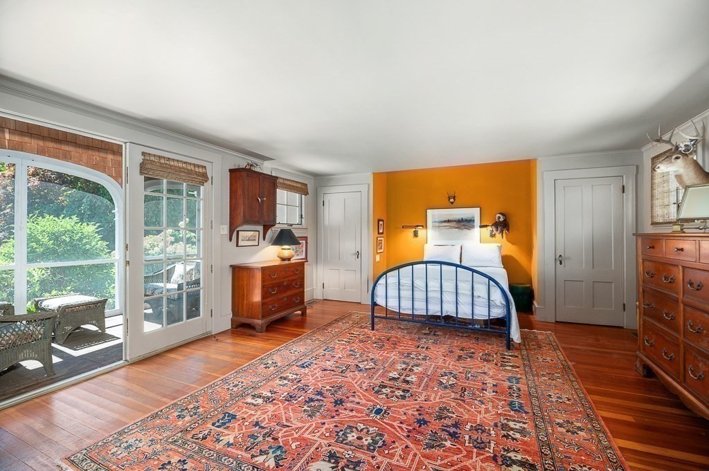 172 Argilla Road Ipswich, MA 01938 - Photo 24 of 34 a bedroom with a bed and wooden floor