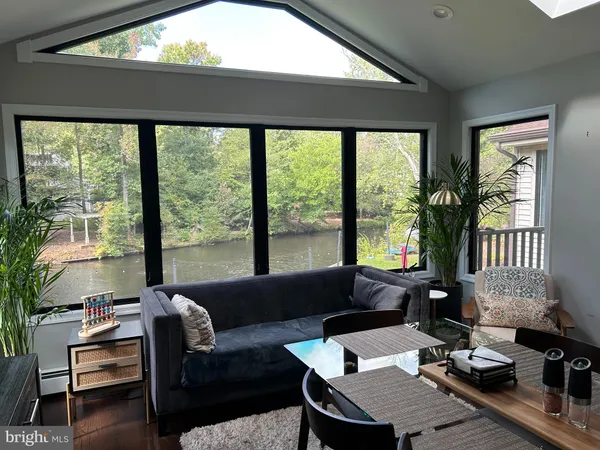 a living room with furniture and large windows