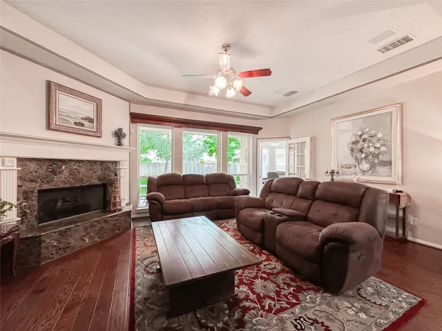 a living room with furniture fireplace and window